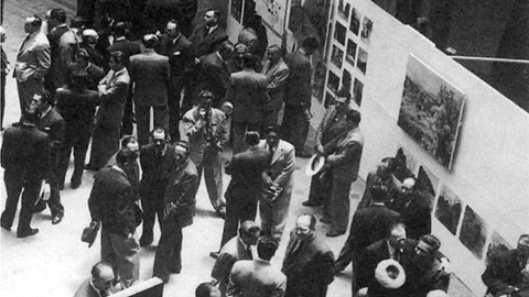 black and white photo of people in a museum