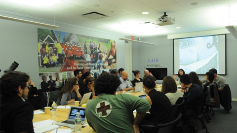 people in a conference room listening to a lecture