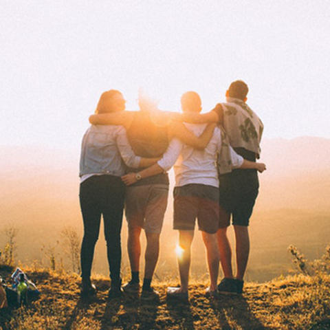 image of 4 people watching a sunset