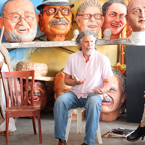 man giving talk with drum in the forefront and artwork in the back